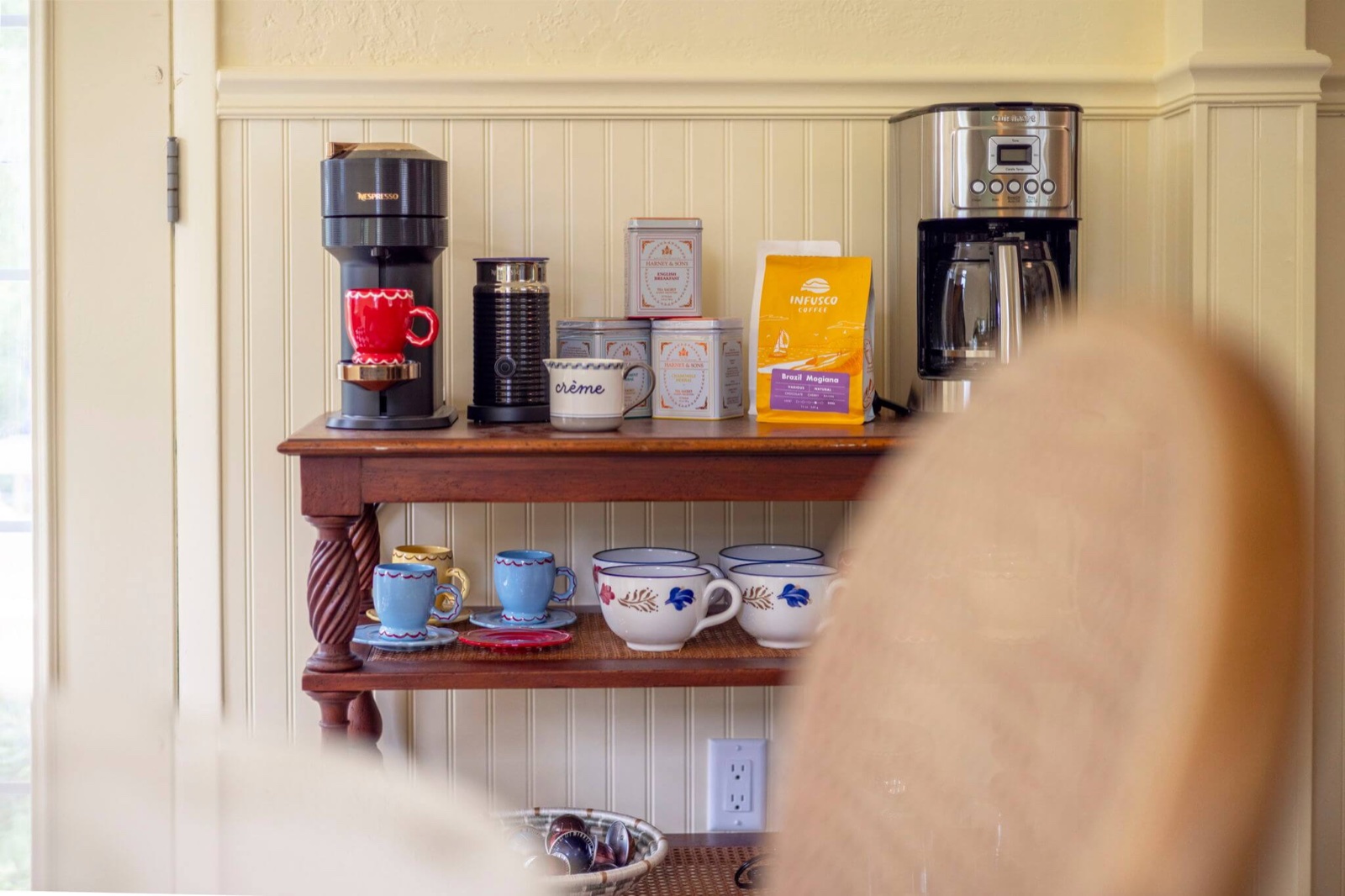 The fully stocked Nespresso and drip coffee station with colorful mugs