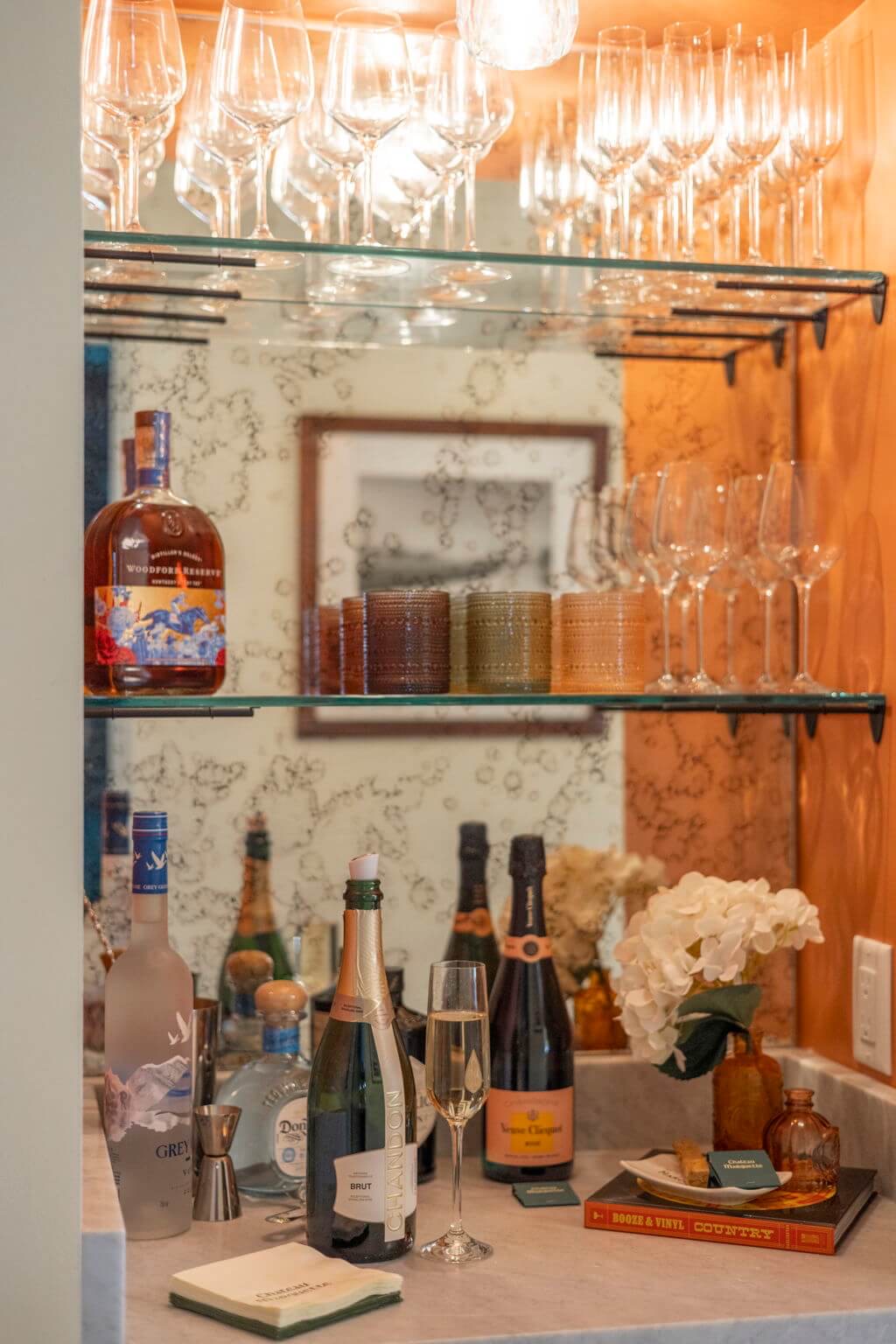 The house bar stocked with glassware, flowers, and Chateau Marquette cocktail napkins