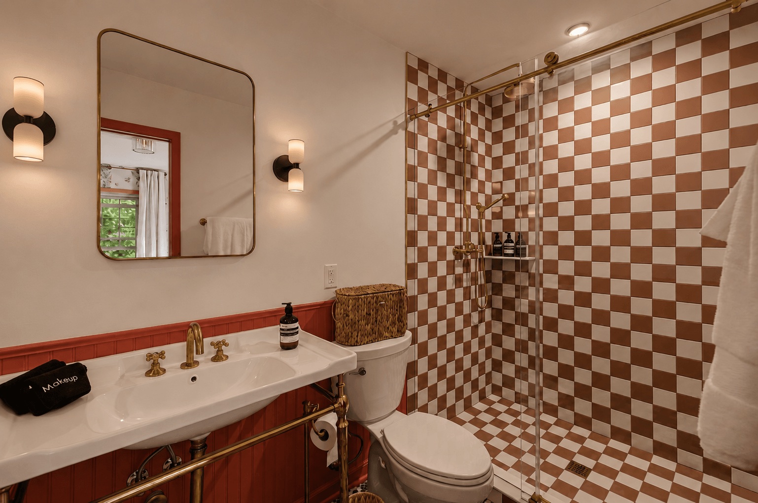 The Rose Suite ensuite with a terracotta checkerboard shower and brass fixtures